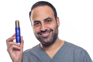 Dr. Ben Talei smiling and presenting AuraSilk bottle held in his hand